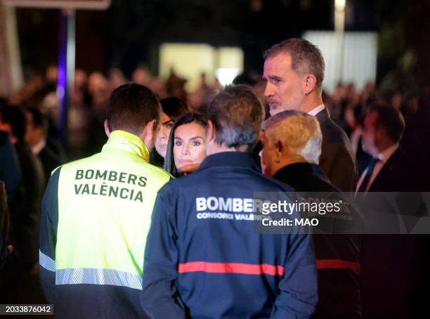 Spain's King Felipe VI and Spain's Queen Letizia speak with members of emergency services during a visit after a huge fire killed ten people in a...