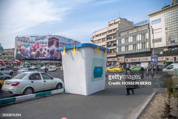An Iranian women passed by an exhibit showcasing a ballot box In Tehran, on February 24, 2024. Signaling the commencement of the election campaign....