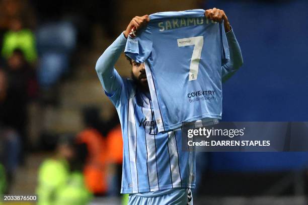 Coventry City's English striker Ellis Simms holds the shirt of his teammate Coventry City's Japanese midfielder Tatsuhiro Sakamoto as he celebrates...