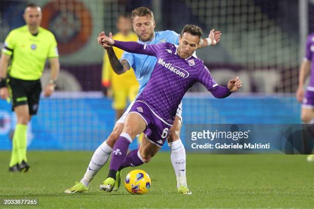 Ciro Immobile of SS Lazio battles for the ball with Arthur Melo of ACF Fiorentina during the Serie A TIM match between ACF Fiorentina and SS Lazio at...