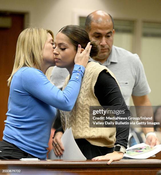 Riverside, CA Julia Barajas, center, receives a kiss and hug from her mother Catherine Barajas, left, as her father Brian Barajas, right, stands near...