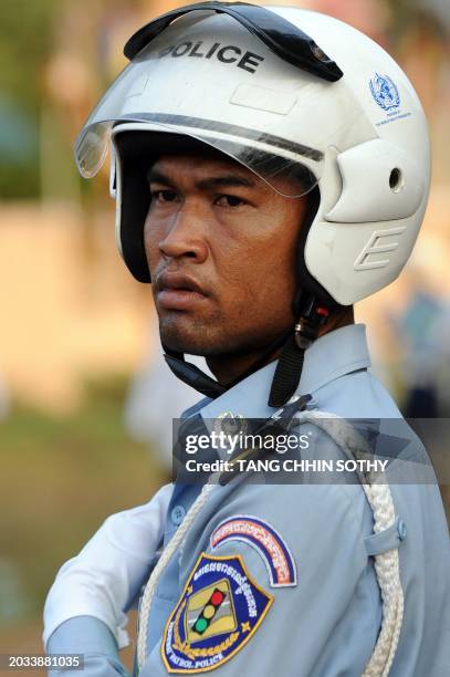 Cambodian traffic police looks on during a ceremony at Oddong mountain in Kandal province, some 40 kilometers north of Phnom Penh on February 7,...