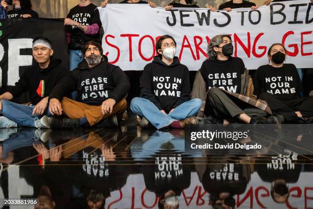 Members of Jewish Voice for Peace and others gather at Rockefeller Center to protest a visit by President Joe Biden on February 26, 2024 in New York...