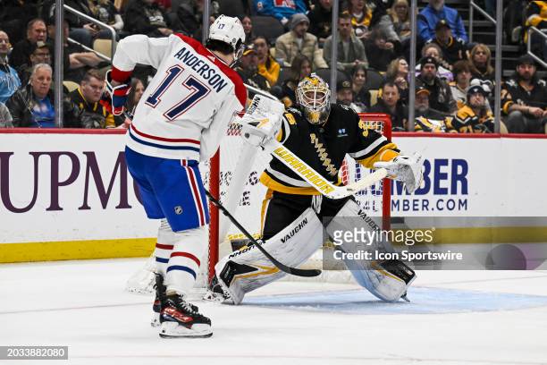 Pittsburgh Penguins goaltender Tristan Jarry makes a save on Montreal Canadiens right wing Josh Anderson in front during the third period in the NHL...