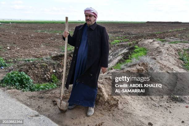 An Iraqi farmer stands at his agricultural land in the region of Hamrin, north of Tikrit, in Iraq's province of Salaheddin, on February 19, 2024. Oil...