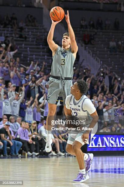 Kerr Kriisa of the West Virginia Mountaineers puts up a shot against Tylor Perry of the Kansas State Wildcats in the first half at Bramlage Coliseum...