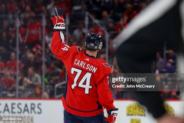 John Carlson of the Washington Capitals acknowledges the fans as he is recognized for most games played by a defenseman in franchise history during a...