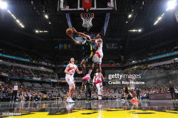 Obi Toppin of the Indiana Pacers drives to the basket during the game against the Toronto Raptors on February 26, 2024 at Gainbridge Fieldhouse in...
