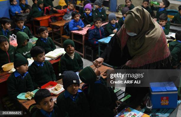 Health worker administers polio vaccine to children during a door-to-door polio vaccination campaign in Lahore February 27, 2024.