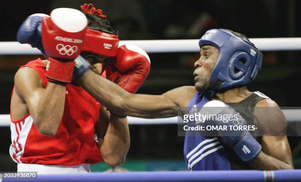 Amir Khan of Great Britain defends against Mario Cesar Kindelan Mesa of Cuba during their lightweight boxing match at the Peristeri Boxing Hall 29...