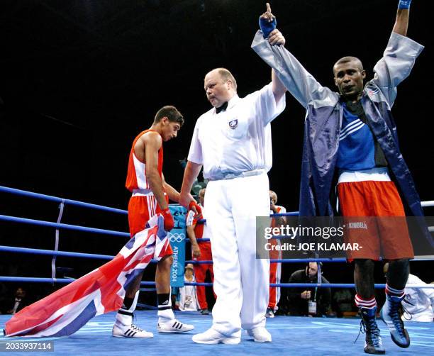 Amir Khan of Great Britain carries the British flag following his Olympic Games gold medal match defeat against Mario Cesar Kindelan Mesa of Cuba in...