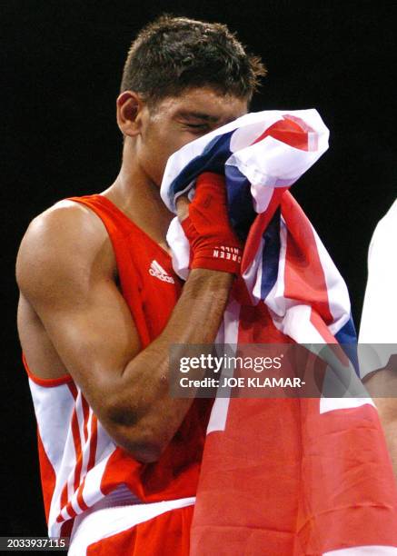 Amir Khan of Great Britain kisses the British flag following his lightweight boxing match against Mario Cesar Kindelan Mesa of Cuba at the Peristeri...