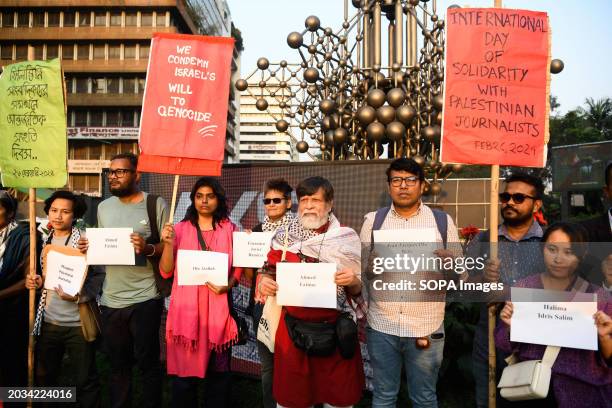 Protesters along with internationally renowned photographer and human rights activist, Shahidul Alam hold placards with names of Journalists, media...