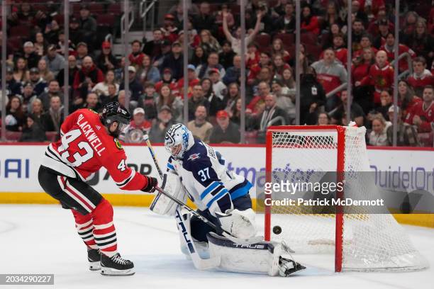 Colin Blackwell of the Chicago Blackhawks scores a goal against Connor Hellebuyck of the Winnipeg Jets during the second period at the United Center...