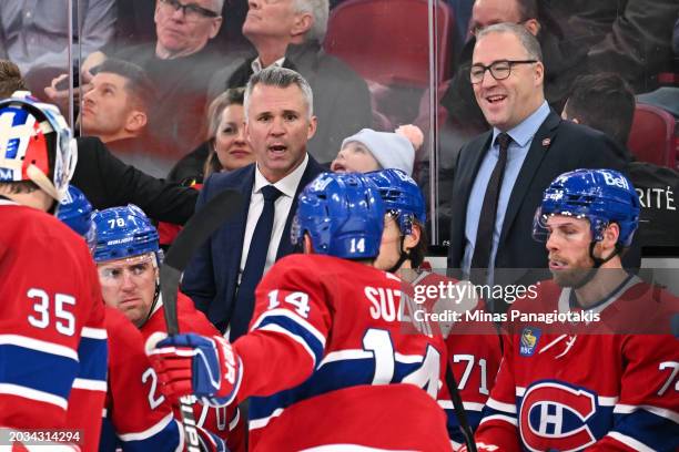 Head coach of the Montreal Canadiens Martin St-Louis and assistant coach Stephane Robidas speak with players during the third period against the...