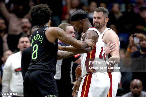 Naji Marshall of the New Orleans Pelicans and Jimmy Butler of the Miami Heat are involved in an altercation during the fourth quarter of an NBA game...