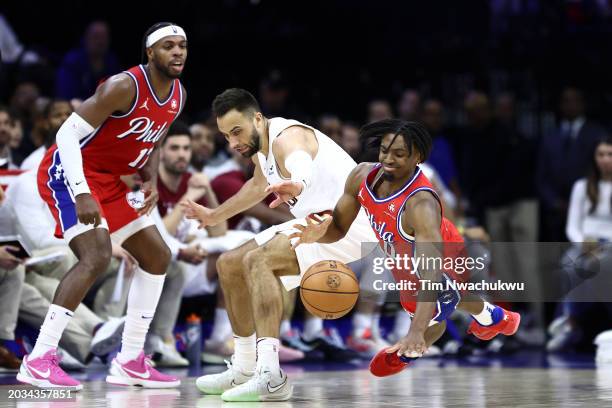 Max Strus of the Cleveland Cavaliers and Tyrese Maxey of the Philadelphia 76ers challenge for the ball during the third quarter at the Wells Fargo...