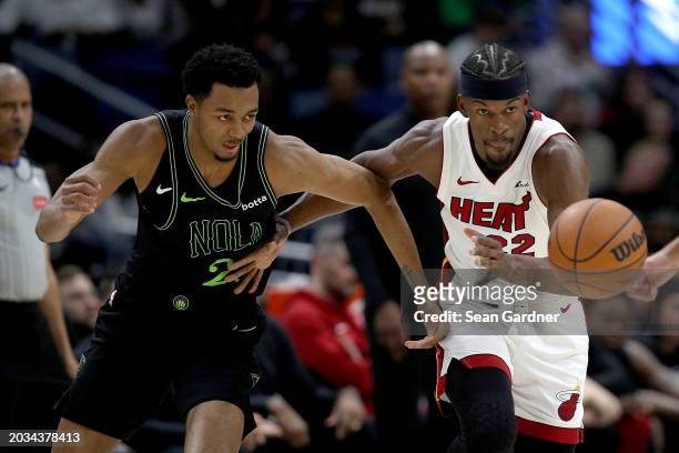 Jimmy Butler of the Miami Heat steals the ball form Herbert Jones of the New Orleans Pelicans during the fourth quarter of an NBA game at Smoothie...