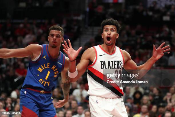 Toumani Camara of the Portland Trail Blazers and Michael Porter Jr. #1 of the Denver Nuggets react to a call during the second quarter at Moda Center...