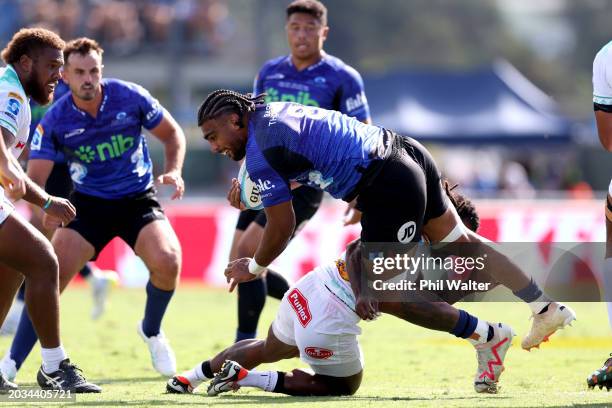 Hoskins Sotutu of the Blues is tackled during the round one Super Rugby Pacific match between the Blues and Fijian Drua at Semenoff Stadium, on...