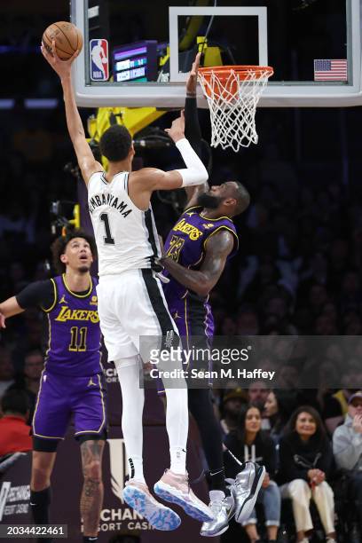 LeBron James of the Los Angeles Lakers defends against a shot by Victor Wembanyama of the San Antonio Spurs during the first half of a game at...