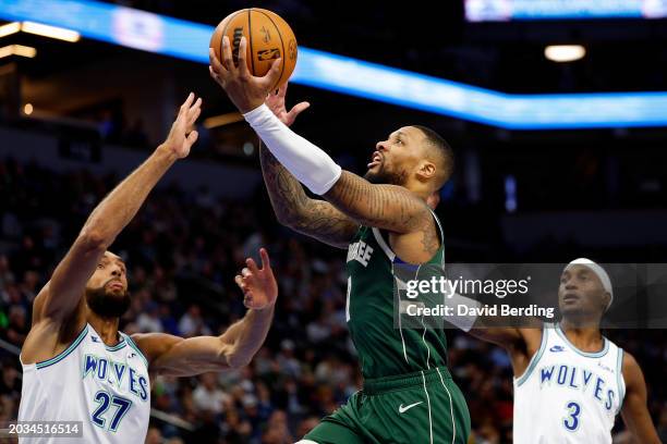 Damian Lillard of the Milwaukee Bucks goes up for a shot against Rudy Gobert of the Minnesota Timberwolves in the third quarter at Target Center on...