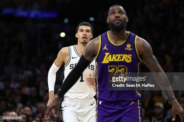 Victor Wembanyama of the San Antonio Spurs looks over the shoulder of LeBron James of the Los Angeles Lakers during the second half of a game at...