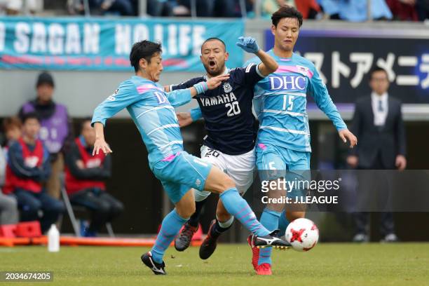 Kengo Kawamata of Júbilo Iwata competes for the ball against Yoshiki Takahashi and Jung Seung-hyun of Sagan Tosu during the J.League J1 match between...