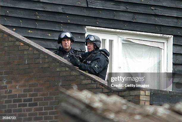 Armed police keep watch on a flat in Marple Square on May 28, 2003 in Nottingham, England. Unarmed police visited the flat on May 27, 2003 with the...