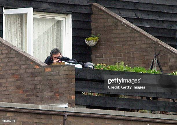 Armed police keep watch on a flat in Marple Square on May 28, 2003 in Nottingham, England. Unarmed police visited the flat on May 27, 2003 with the...