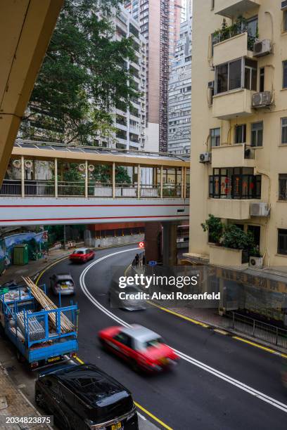 Cards drive through the windy roads on February 22, 2024 in Hong Kong, China. Tourism levels returned to pre-pandemic numbers for the first time as...