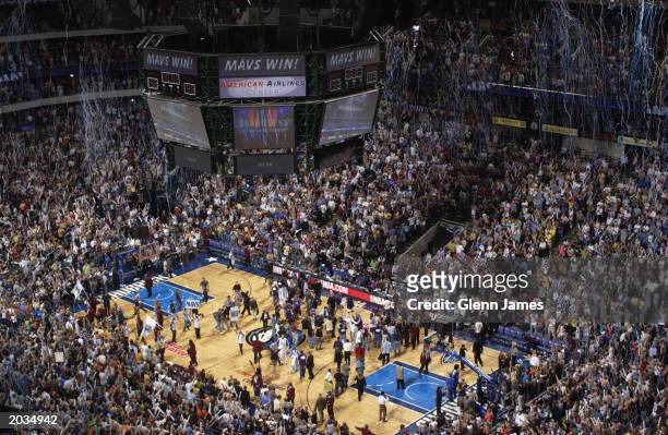 Fans cheer after the Dallas Mavericks defeat the Sacramento Kings in Game seven of the Western Conference Semifinals during the 2003 NBA Playoffs at...