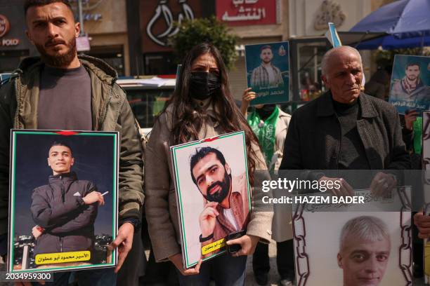 Relatives and friends of Palestinians imprisoned in Israel lift placards and portraits at a rally calling for their release and the return of the...