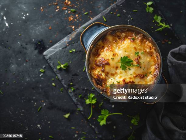 photo of moussaka food on dark slate background - moussaka stock-fotos und bilder