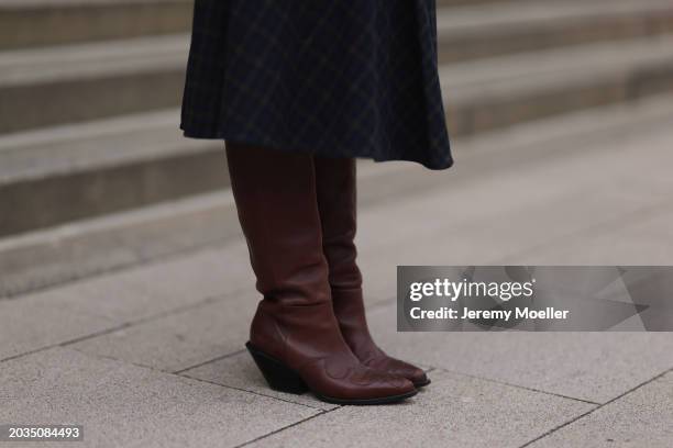 Jennifer Casimiro seen wearing Samsøe Samsøe navy blue / brown checked pleated midi skirt and H&M Studio dark brown leather cowboy heeled boots /...