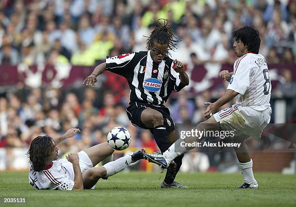 Andrea Pirlo and Gennaro Gattuso of Milan attemp to tackle Edgar Davids of Juventus FC during the UEFA Champions League Final match between Juventus...