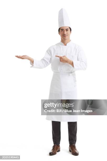 chef making introducing gesture - chefs whites stock pictures, royalty-free photos & images