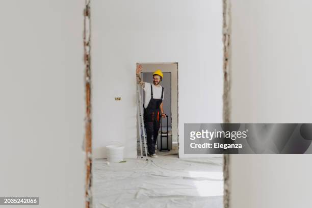 worker man ready for renovation work in new apartment. - handyman overalls stock pictures, royalty-free photos & images
