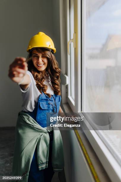 woman builder holding roulette for measuring - centimeter stock pictures, royalty-free photos & images