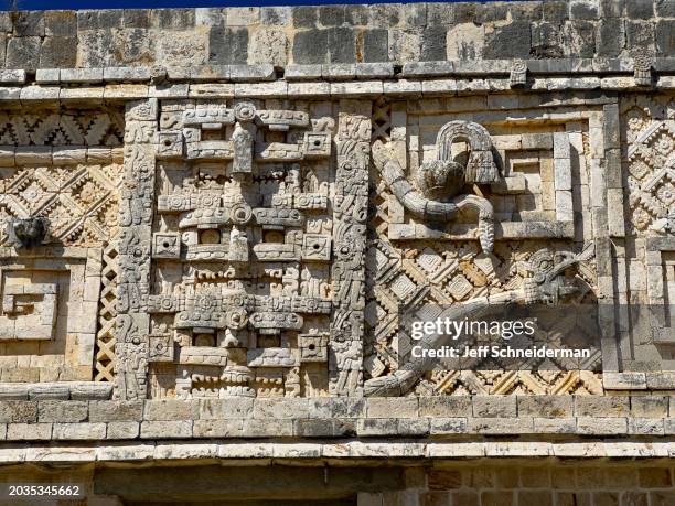 uxmal mayan façade with serpents and face masks - uxmal fotografías e imágenes de stock