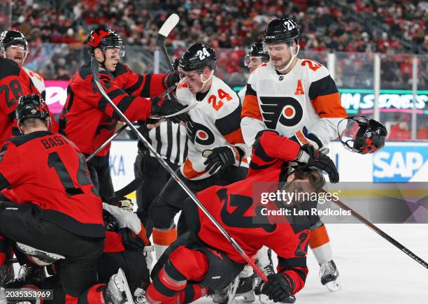 Nick Seeler and Scott Laughton of the Philadelphia Flyers involved in a scuffle during the 2024 Navy Federal Credit Union Stadium Series game against...