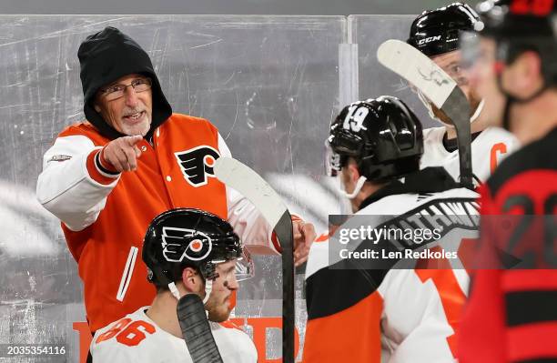 Head coach John Tortorella of the Philadelphia Flyers reacts to the play on the ice from behind the bench during the 2024 Navy Federal Credit Union...