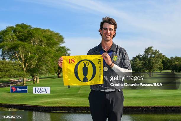 Altin Van Der Merwe of South Africa poses with an Open Championship flag following his victory in a playoff during day four of the Africa Amateur...