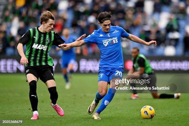 Matteo Cancellieri of Empoli FC is challenged by Marcus Holmgren Pedersen of US Sassuolo during the Serie A TIM match between US Sassuolo and Empoli...