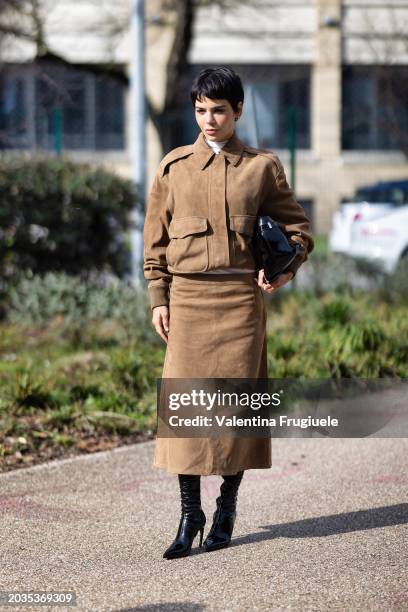 Guest is seen wearing a white turtle neck sweater, a black bag, black leather boots khaki suede matching set made of a cargo jacket and a long skirt...