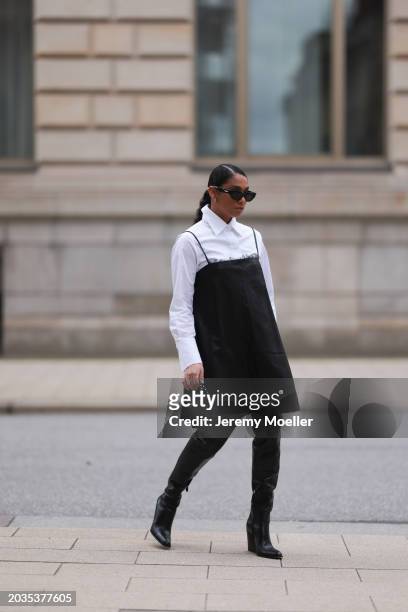 Cherifa Akili seen wearing Bottega Veneta black sunglasses, gold earrings, Seidensticker x Cloudy Z white buttoned shirt, Dorothee Schuhmacher black...