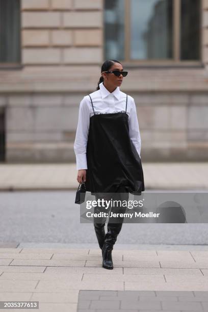 Cherifa Akili seen wearing Bottega Veneta black sunglasses, gold earrings, Seidensticker x Cloudy Z white buttoned shirt, Dorothee Schuhmacher black...