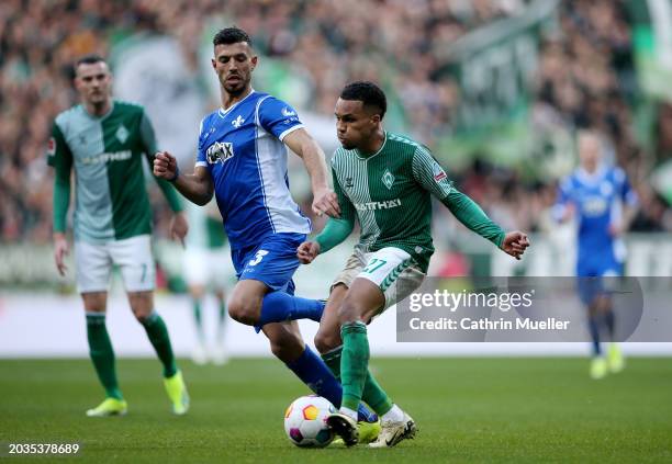 Felix Agu of SV Werder Bremen is challenged by Klaus Gjasula of SV Darmstadt 98 during the Bundesliga match between SV Werder Bremen and SV Darmstadt...