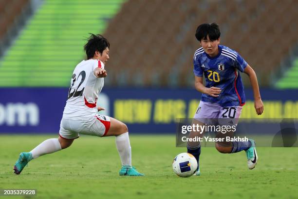 Toko Koga of Japan runs with the ball whilst under pressure from Kim Hye-Yong of North Korea during the AFC Women's Olympic Football Tournament Paris...