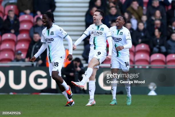 Ryan Hardie of Plymouth Argyle celebrates scoring his team's second goal with teammates Mickel Miller and Darko Gyabi during the Sky Bet Championship...